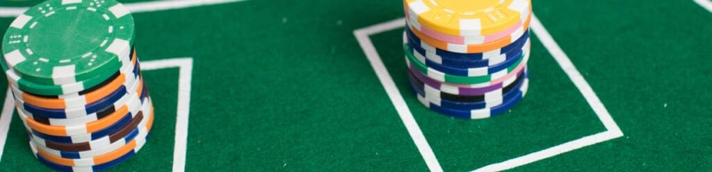 Casino chips on a green poker table.
