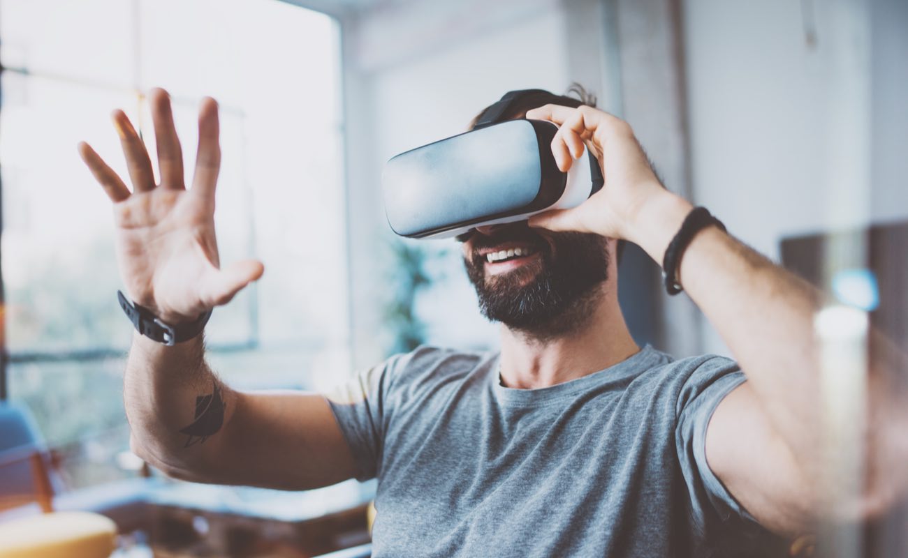 Man wearing virtual reality glasses in modern interior design studio