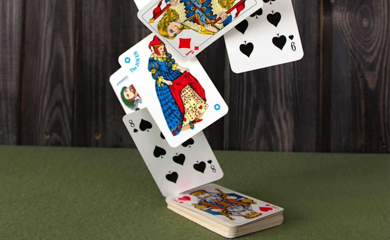  Playing cards on a green felt table.