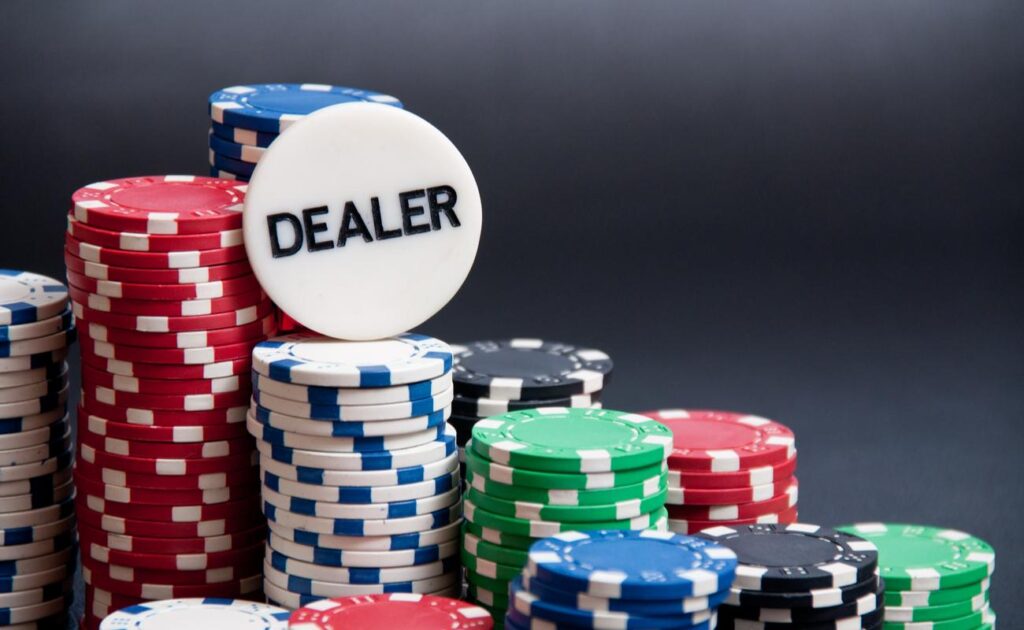 Casino chips with a dealer chip on top.