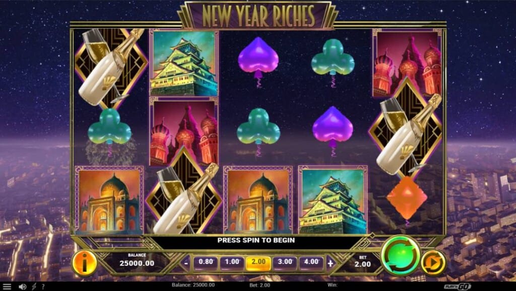 A screenshot of the slot reels for New Year Riches. The background is a beautiful city and sky at night. In the foreground are the slot reels, filled with various iconic landmarks from around the world, New Year-themed symbols, and card suit symbols.