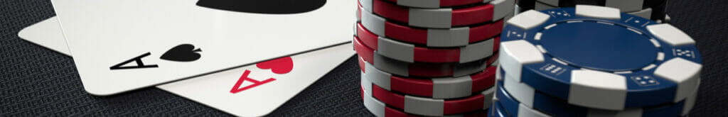 Two Ace cards next to some poker chips.