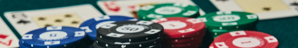 Two hole cards, face down in a game of poker, next to stacks of poker chips.