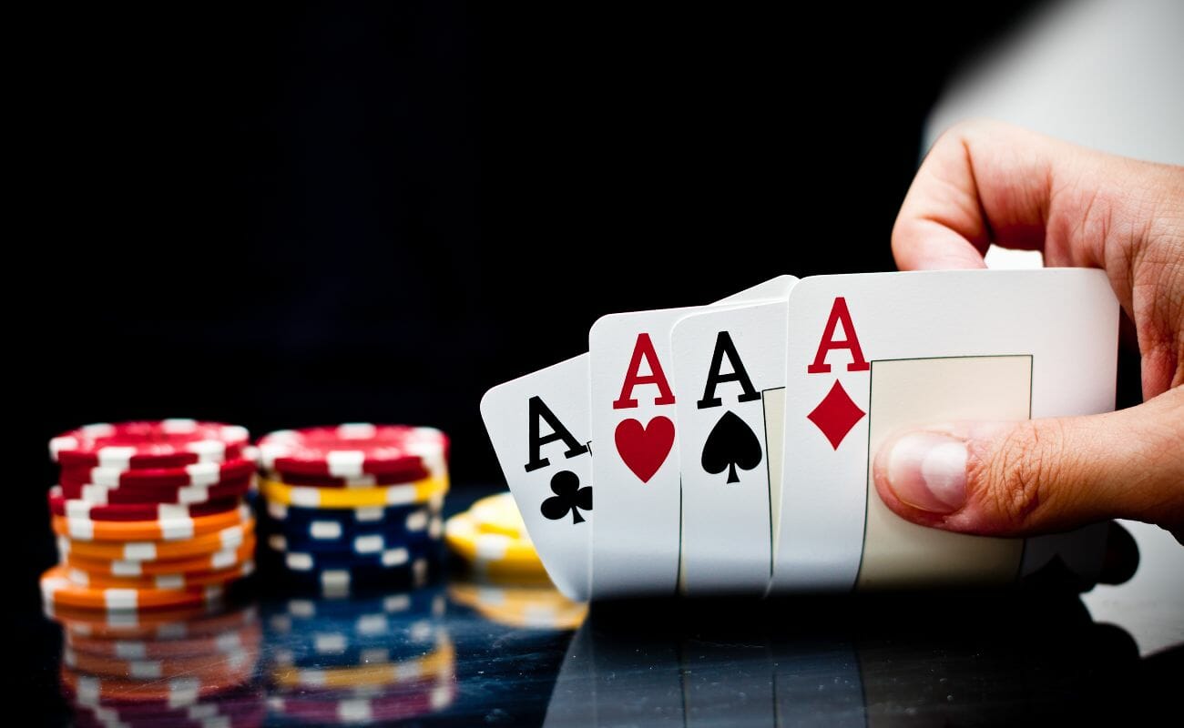 Four aces with casino chips on the table
