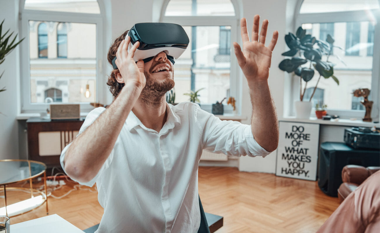A person enjoying VR goggles at their desk.