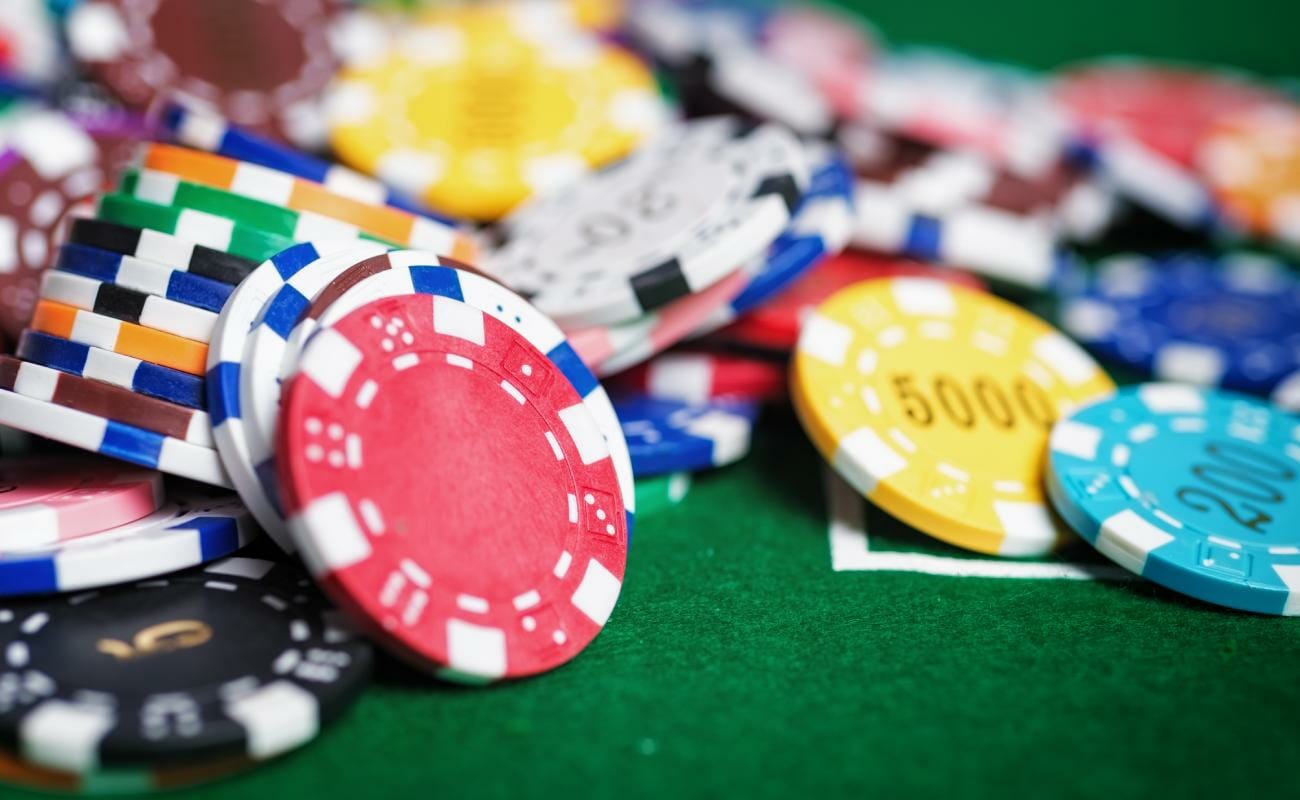Casino poker chips on a green felt table.