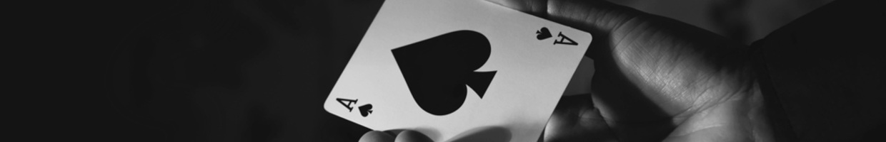 A person holding an ace of spades