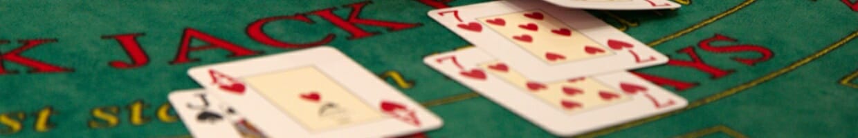 A few cards on a blackjack table.