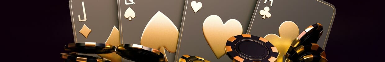 Four black and gold playing cards sit behind stacks of black and gold poker chips.