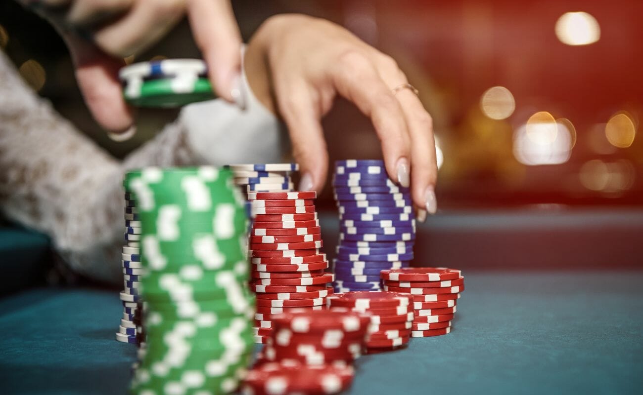 A person picks up poker chips.