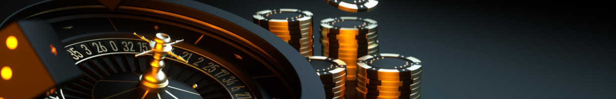 A black and gold roulette wheel, dice and chips.