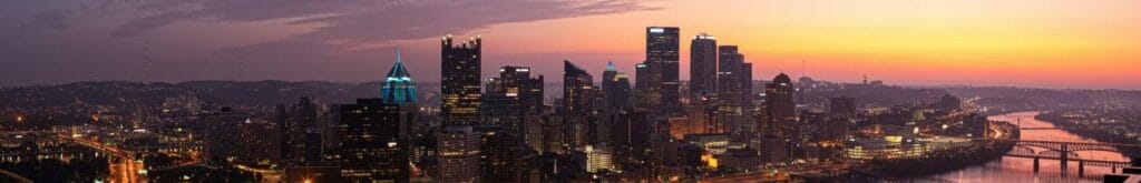 Pittsburgh, Pennsylvania skyline at dawn with the sun setting