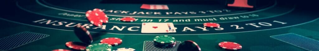 Blackjack table with playing cards and poker chips scattered around it