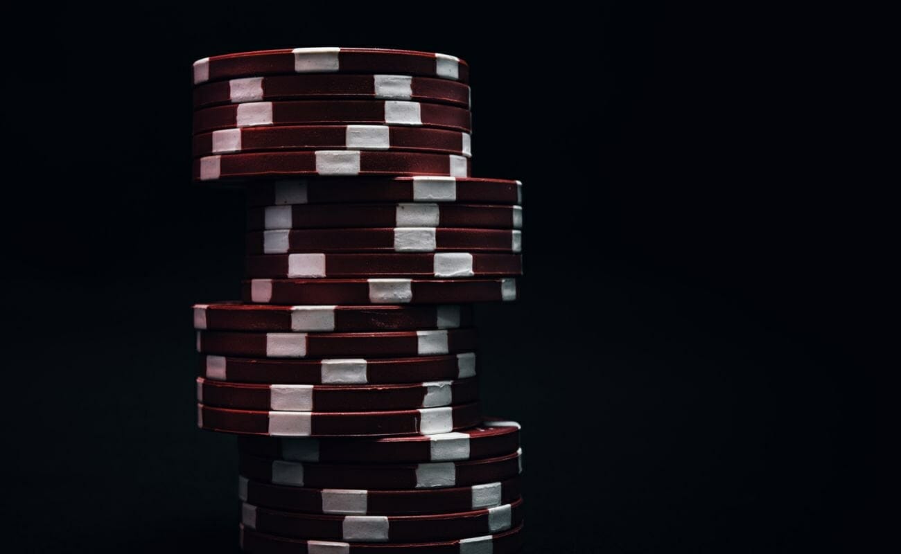 red poker chips stacked with a black background