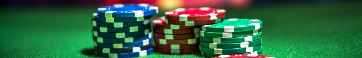 poker chips stacked on a green felt poker surface