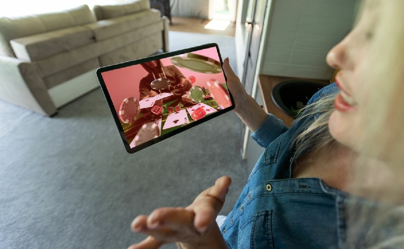 A woman watching someone play poker on her tablet
