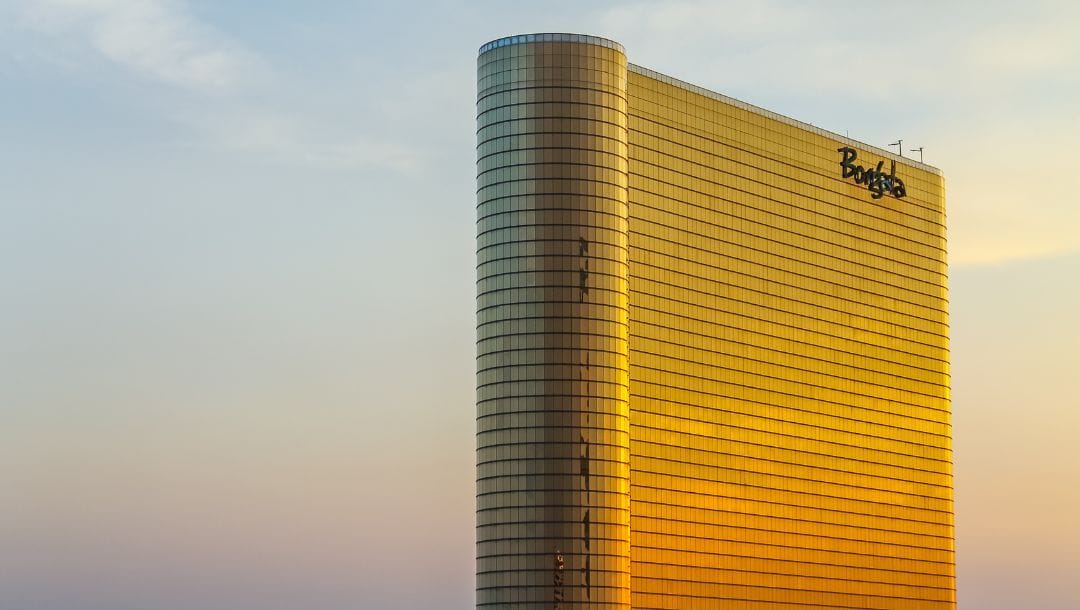 Exterior of the Borgata Hotel Casino & Spa in Atlantic City, New Jersey, with its golden glass facade glowing at sunset.