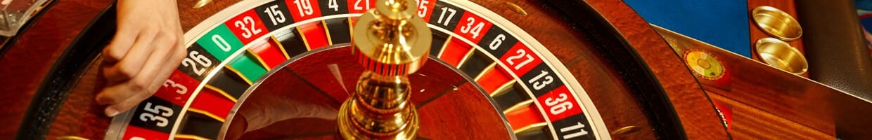 A croupier about to start a game of roulette.