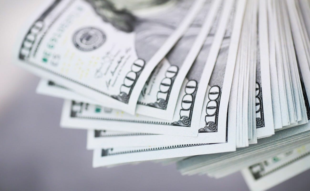 A stack of $100 bills spread out.
