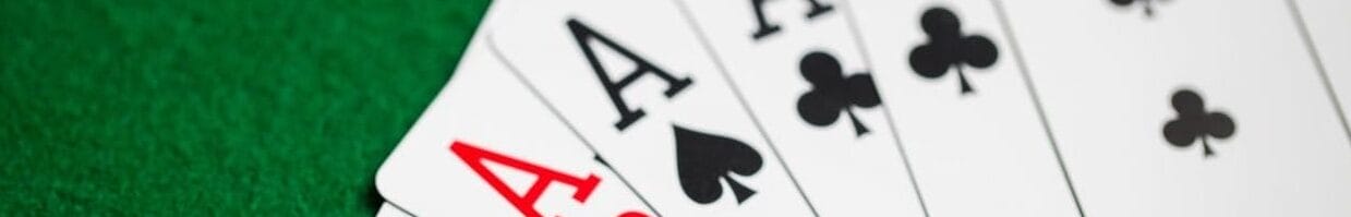 An Ace of diamonds, an Ace of hearts, an Ace of spades, an Ace of clubs, and a three of clubs.