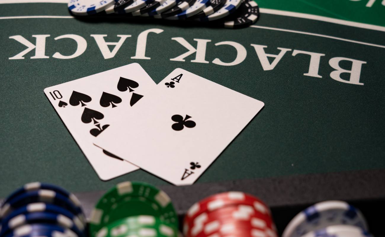 Playign cards and casino chips on a blackjack table.
