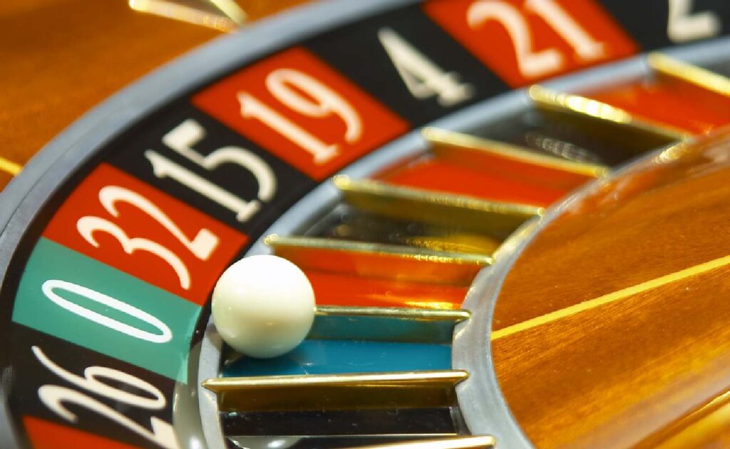 A ball on the green 0 number on a roulette wheel.