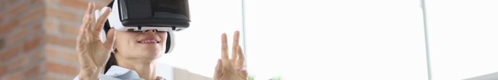 a woman is wearing a virtual reality headset while holding her hands up in front of her
