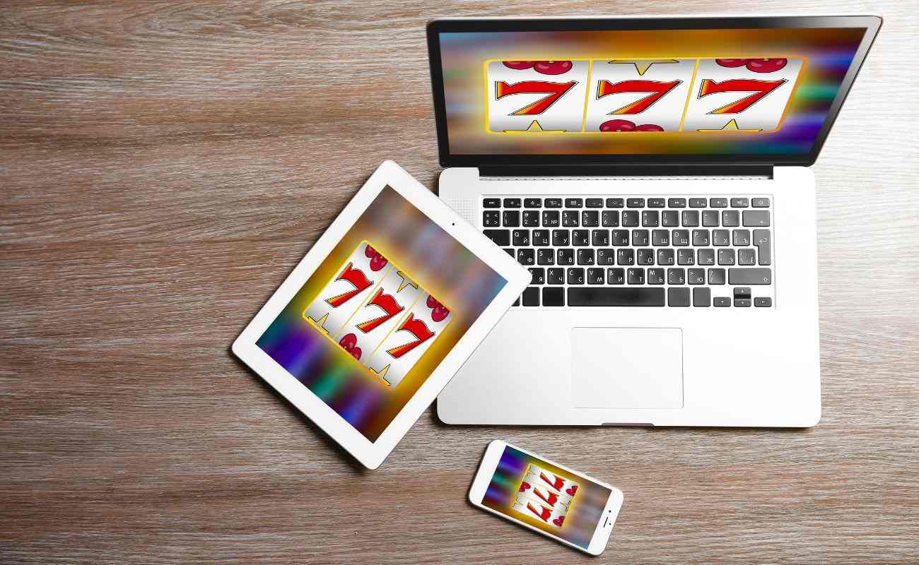 An online slot game displayed on a phone, a tablet, and a laptop. 