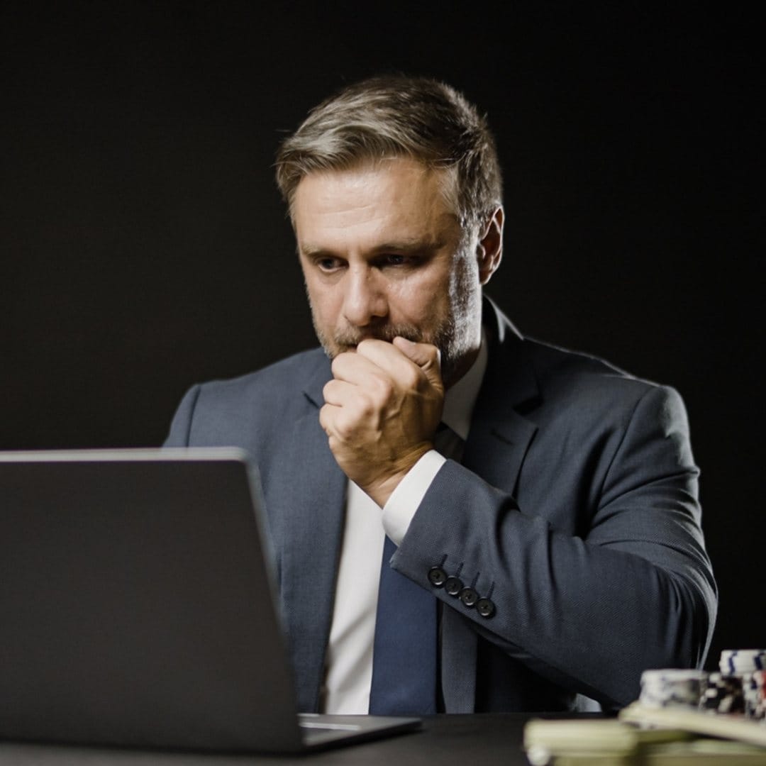 A man concentrates on an online poker game