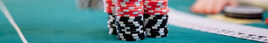 Casino chips and playing cards on a poker table.