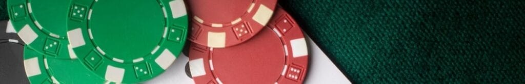 Casino chips and playing cards scattered on a casino table.