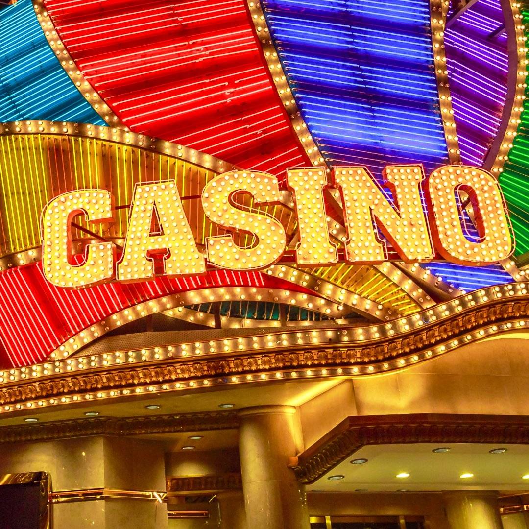 A bright casino sign outside the entrance to a casino.
