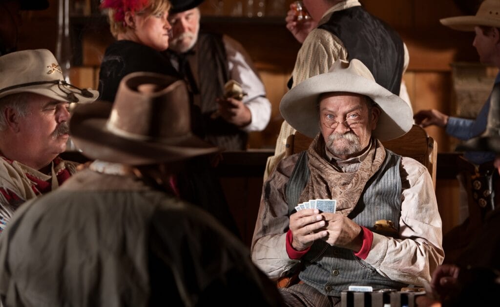 Old cowboys playing poker in a saloon