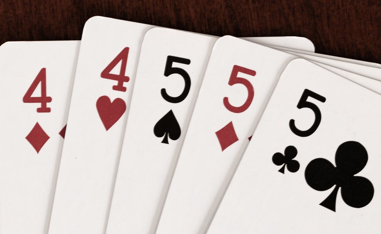 A pair of 4s and three 5s on a table.