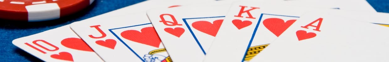 Playing cards winning combination on a blue felt table.