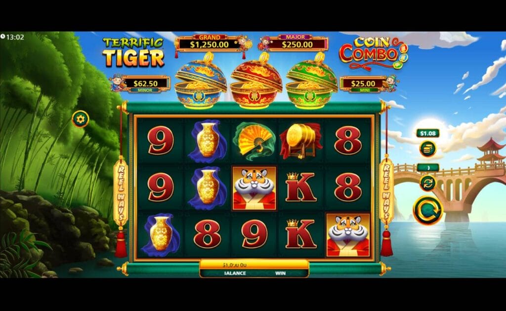 A screenshot of the reels in Terrific Tiger Coin Combo. The game is set between a lush green forest and a picturesque stone bridge heading across a lake. The reels are in the center of the screen and contain a variety of symbols, including a cartoon tiger in a royal outfit, a vase, a fan, and a Chinese drum. Additional symbols include a K, 8, and 9. Above the reels are three different colored bowls and the jackpot prizes.