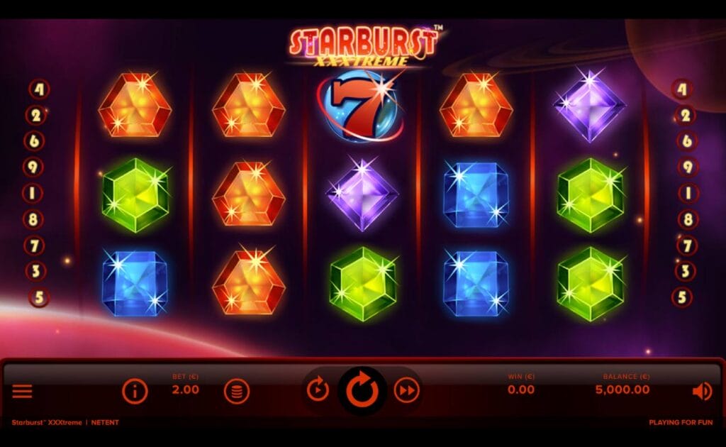 Starburst XXXtreme online slot game with blue, green, purple, and orange gemstone symbols on the reels. The control panel is below the reels and it is red and black. The Starburst XXXtreme logo is red and gold.