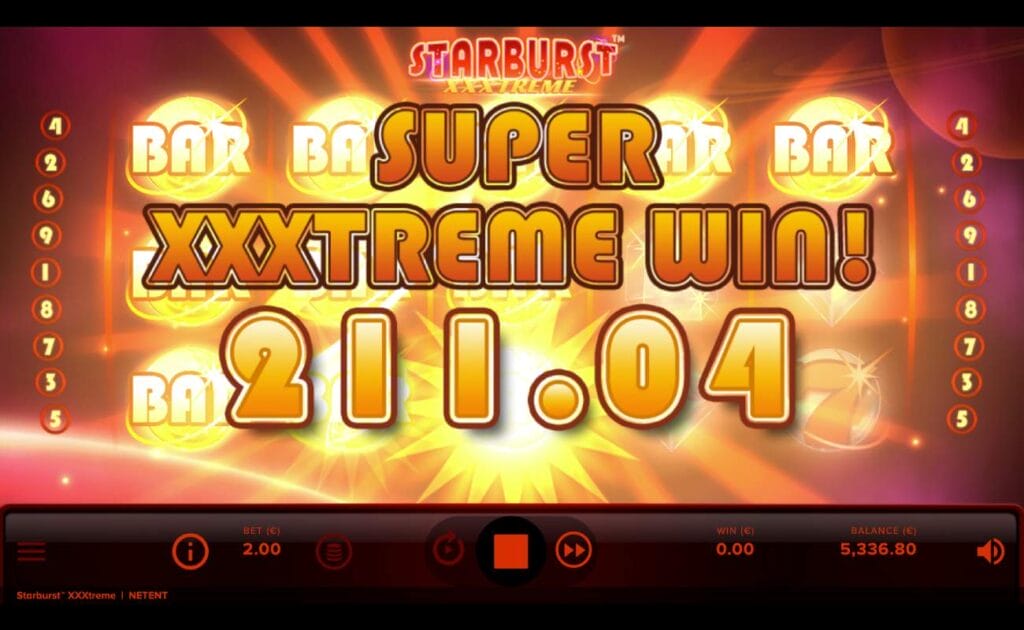 Starburst XXXtreme online slot game with a Super XXXtreme win of 211.04 across the red and gold reels. The font is large and in gold. The control panel is situated at the bottom of the screen and it is black and red.