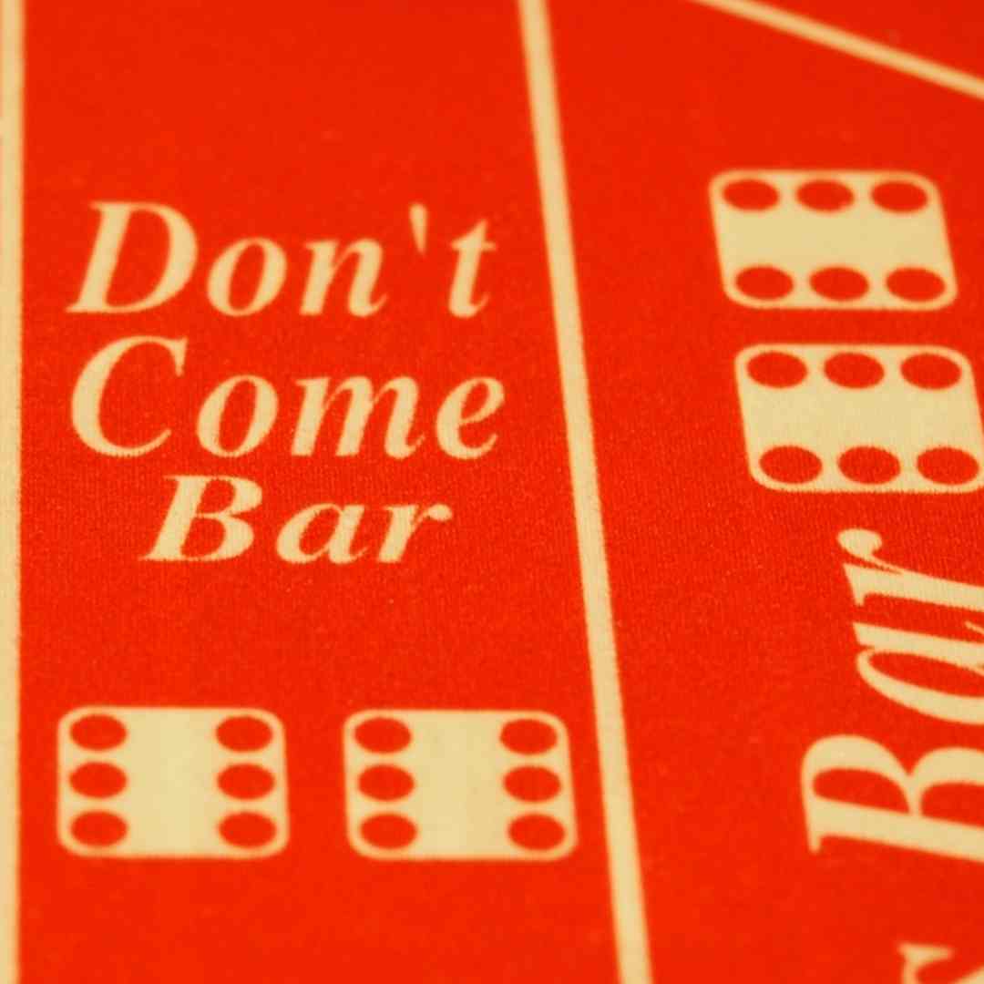 A close-up of the don’t come bar on a red felt craps table.
