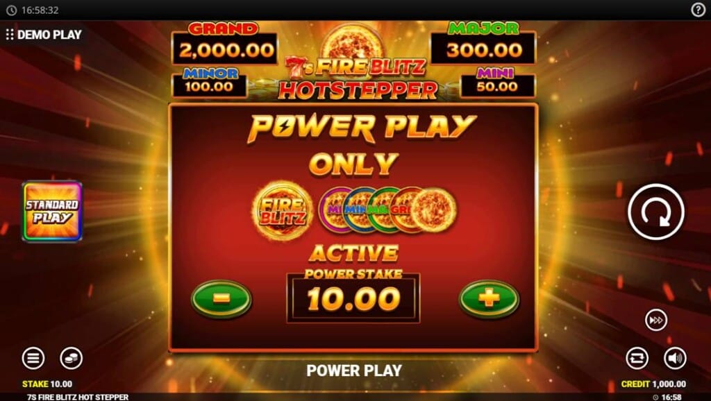 A screenshot of the Power Play feature in Fire Blitz Hotstepper. In the backdrop is a pulsating orange ring of energy with beams of light around it. In the foreground is a red square with the words “Power Play Online” in it as well as images of the active cash, cashpot, and cash collect symbols. The Active Power Stake is set to $10. The jackpots are visible above the Power Play area, the Standard Play toggle is visible on the left, and the game interface is on the right.