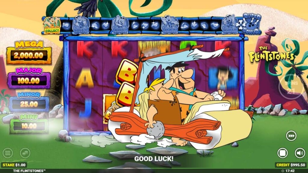 A screenshot of the Yabba Dabba Doo feature triggering. In the foreground are Barney and Fred, who have appeared in front of the reels in their prehistoric car. In the backdrop are the spinning reels, as well as the game’s prehistoric Bedrock lawn background. On the left of the reels are the four jackpot rewards. Above the reels is the bonus prize meter. To the right of the reels is the game interface. 