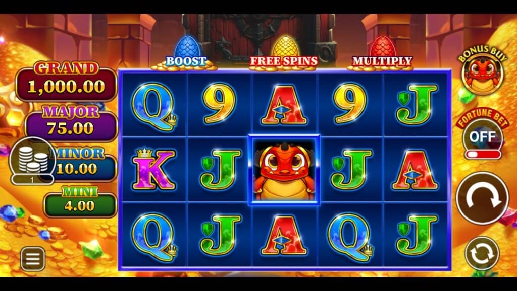 A screenshot of the slot reels in the Happy Fortune Dragon slot game. The game is set in a glittering, treasure-filled cavern with golden coins, sparkling gems, and stone walls in the background. In the foreground, the reels are filled with A, K, Q, J, and 9 symbols, with a cheerful red dragon symbol in the center reel. At the top of the screen are three colored dragon eggs labeled “BOOST,” “FREE SPINS,” and “MULTIPLY”. On the left-hand side are the four jackpot prizes, and on the right-hand side, the game interface.