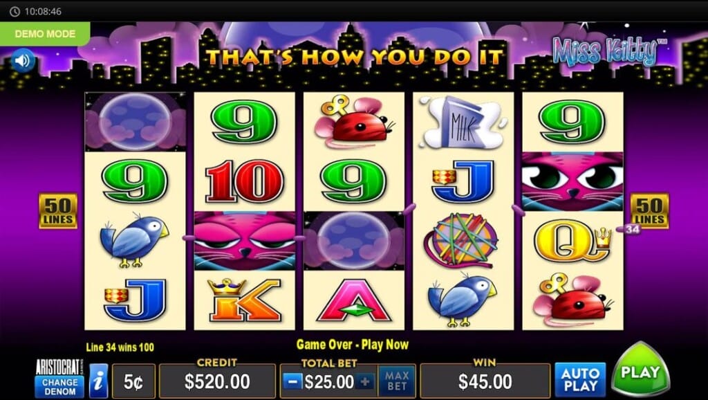 A screenshot of a win screen in the Miss Kitty slot game. The game is set against a nighttime city skyline with a glowing purple sky and the text “THAT’S HOW YOU DO IT” illuminated above the reels. The reels are populated with playful, animated icons like green 9s, pink wind-up mice, cartons of milk, blue birds, colorful yarn balls, and the signature pink cat wild symbol. The purple and cream color scheme is consistent throughout the game, and a yellow "50 LINES" marker is positioned on both sides of the grid. Line 34 is highlighted, indicating a win, with the text "Line 34 wins 100" appearing at the bottom. Below the slot reels is the game interface.