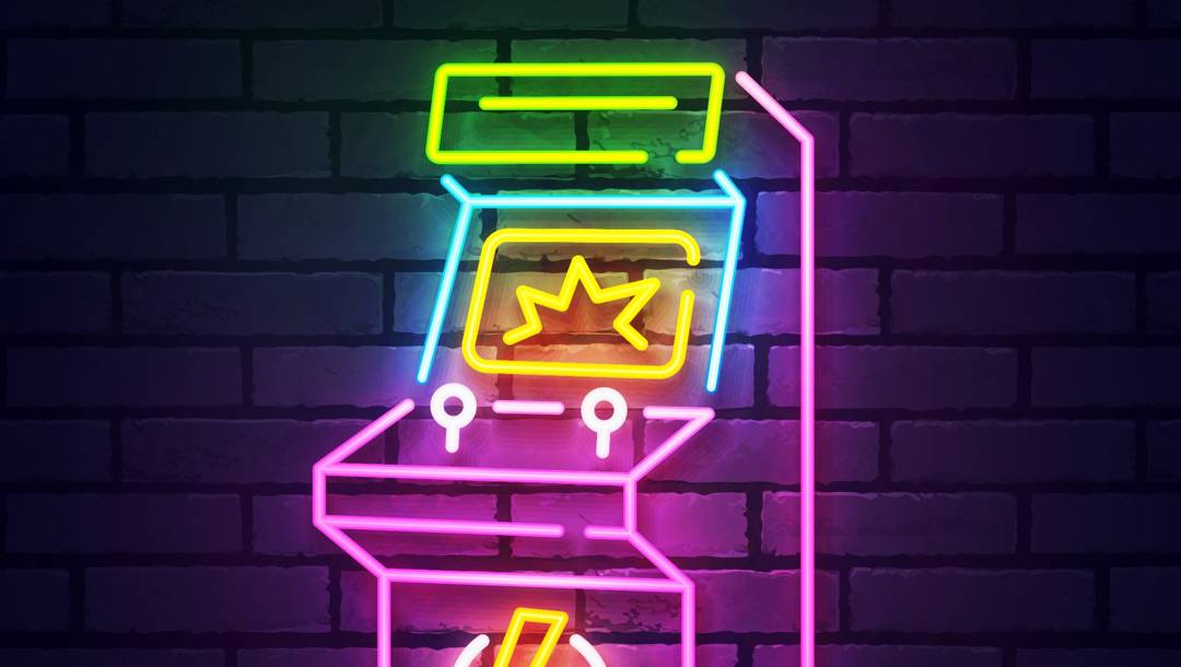 An outline of an arcade machine made up of different colored neon lights.