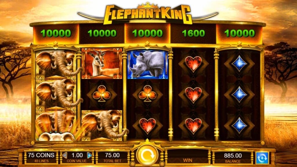 A screenshot of the Elephant King slot game shows five golden-framed reels with vibrant symbols, including elephants, a gazelle, a rhino, and playing card suits. The top of the screen displays high green payout values, while the bottom panel shows the game controls and bet settings. The background is high contrast, an amber African savannah with a setting sun and silhouettes of trees on the horizon.