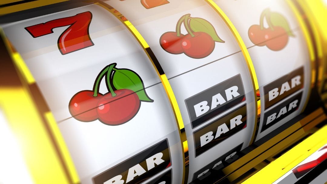 Close-up of a spinning slot machine reel with cherry, BAR, and red 7 symbols, framed by a shiny gold casing.