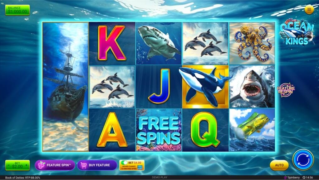 A screenshot of the Ocean Kings slot reels. The background is the ocean floor with light shining through the water. The slot reels feature a range of ocean-themed symbols, including a shipwreck, a pod of dolphins, an orca, and a great white shark, as well as playing card symbols.