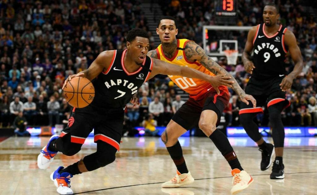 Kyle Lowry of Toronto Raptors drives past Jordan Clarkson of Utah Jazz during a game at Vivint Smart Home Arena
