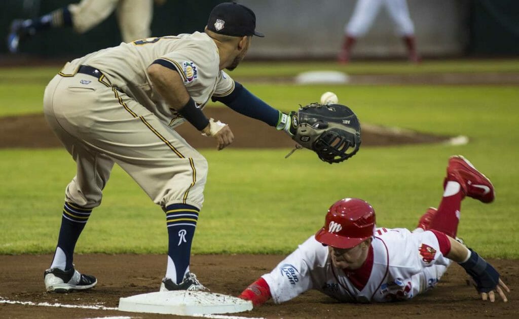 Baseball field with man trying to tag out.