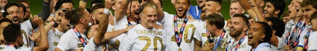 Leeds players celebrate manager Marcelo Bielsa with the trophy during the Sky Bet Championship July 2020. Photo by Michael Regan/Getty Images